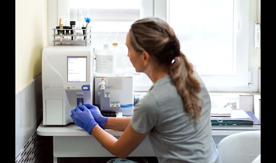 Veterinary tech works with lab equipment