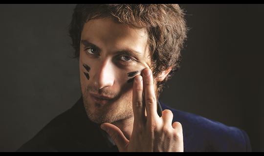 Man applying war paint to his face