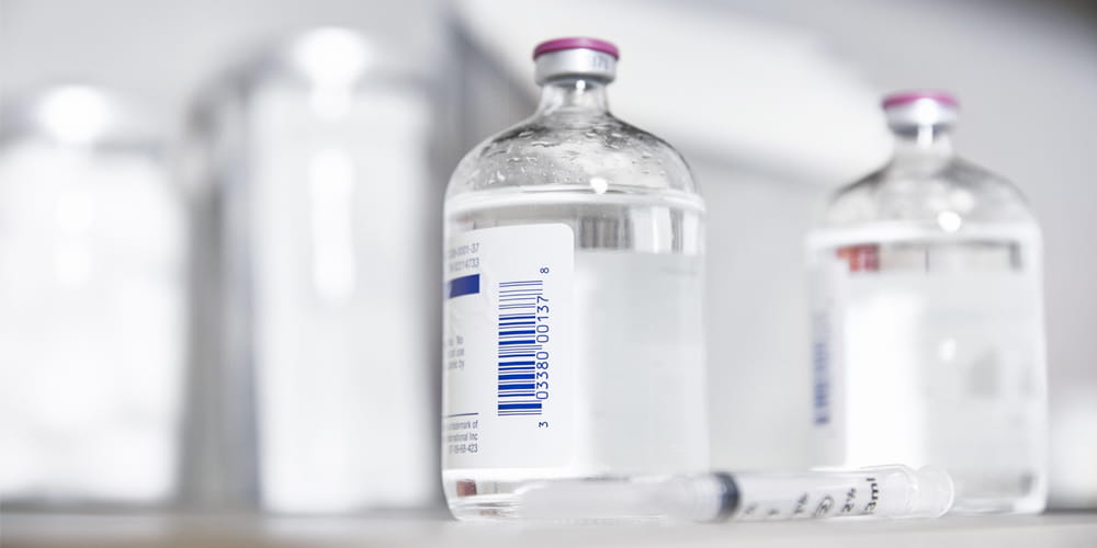 Injectable bottles with syringe on counter